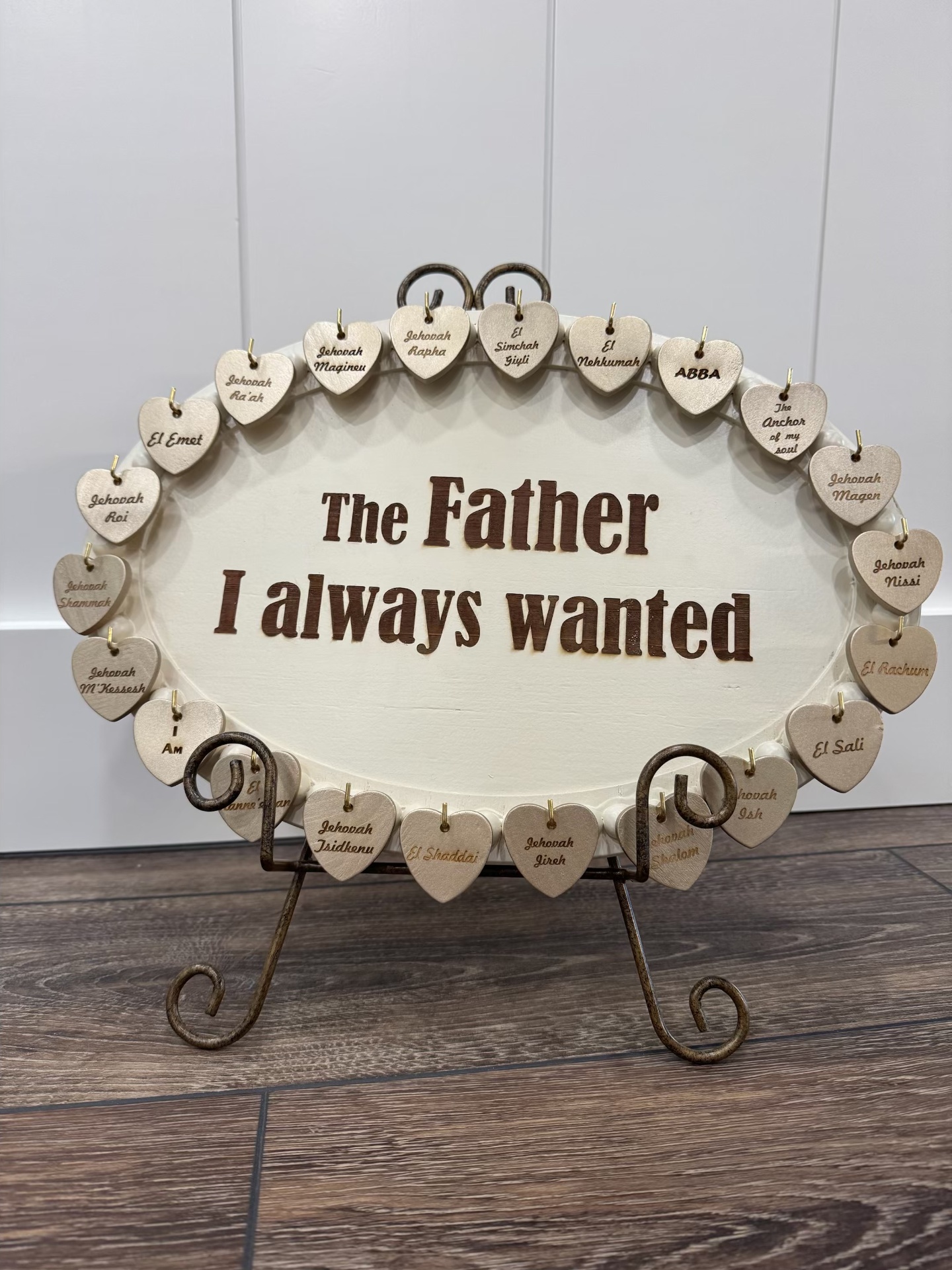 Cream oval board reading "The Father I always wanted" with hanging heart name tokens