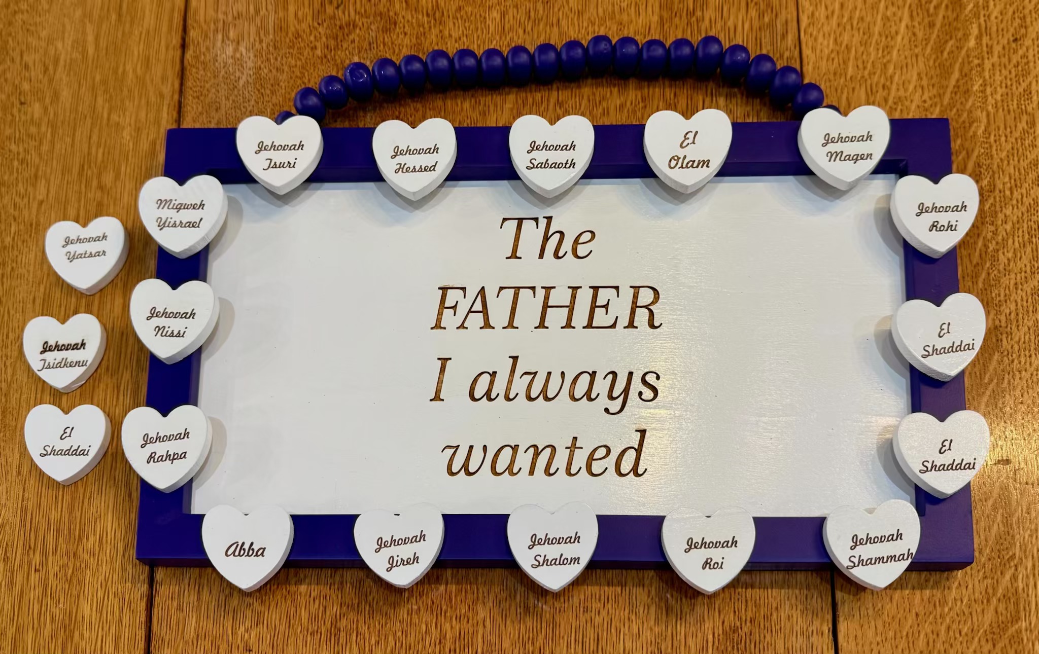 Purple framed 14x8" board reading "The Father I always wanted" with a beaded hanger and white heart name tokens