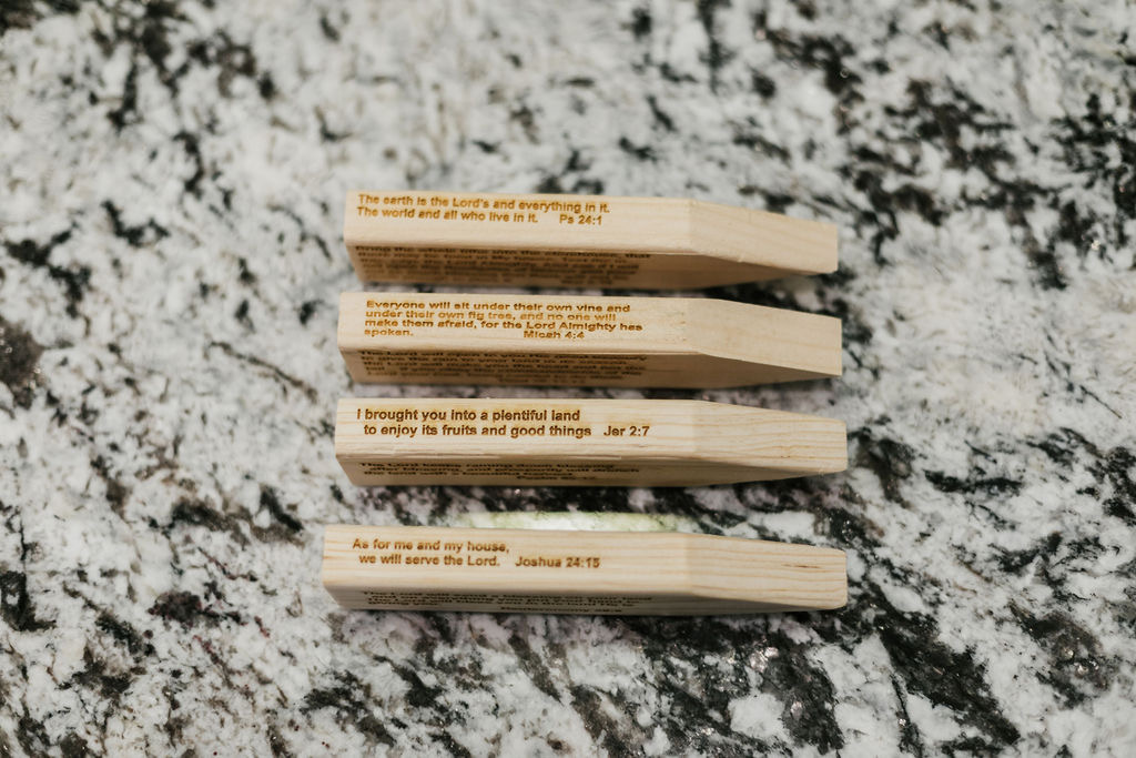 Engraved wooden stakes with Scripture — Psalm 24:1, Micah 4:4, Jeremiah 2:7, Joshua 24:15
