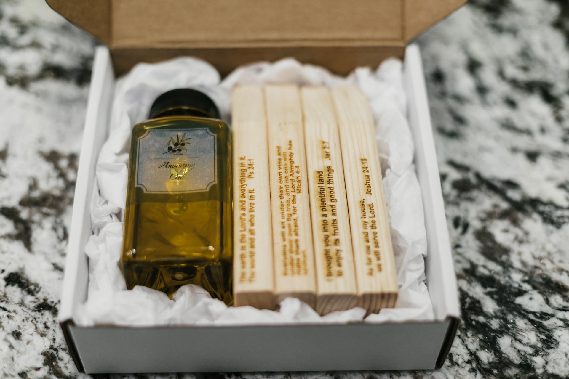 Anointing oil and engraved scripture stakes packaged in the kit box