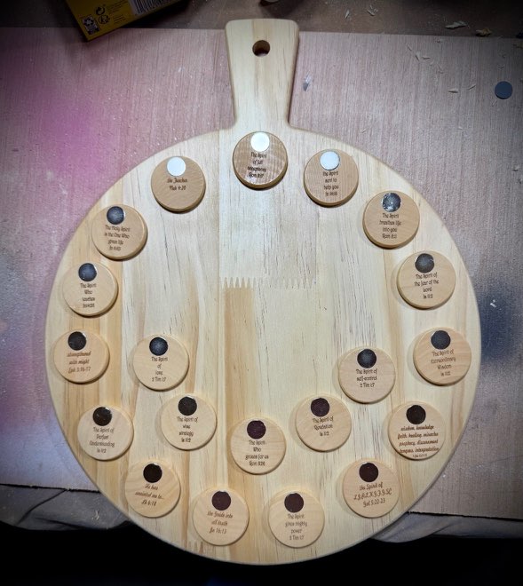 Close-up of the "Holy Spirit my best Friend" board showing all the engraved round name tokens
