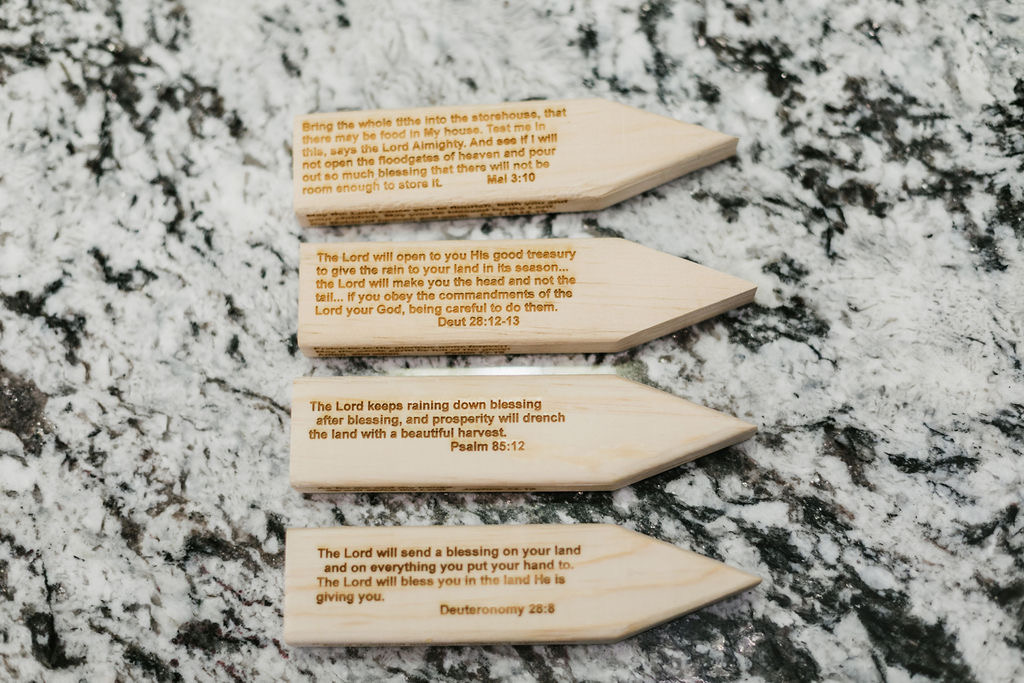 Engraved wooden stakes with Scripture — Malachi 3:10, Deuteronomy 28, Psalm 85:12